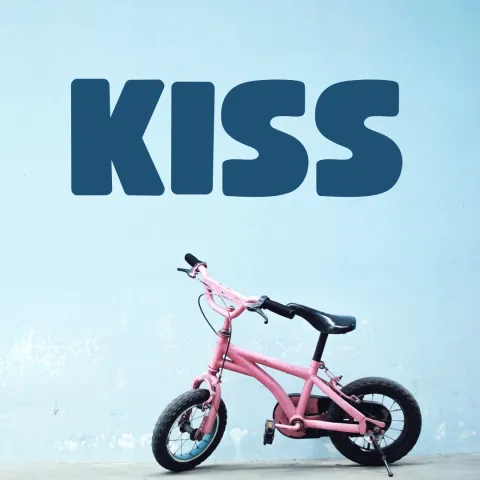 pink bike on blue background, dark blue text reads "KISS"